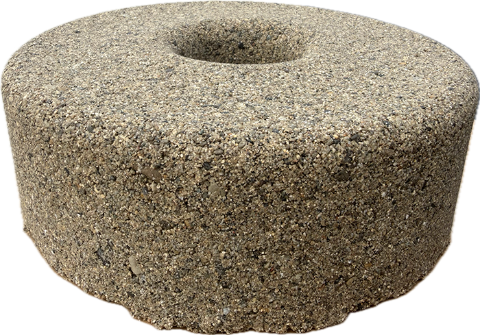 Round sand-covered object with a center hole.